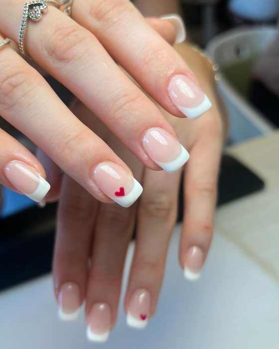 French tip nail extensions with a heart accent